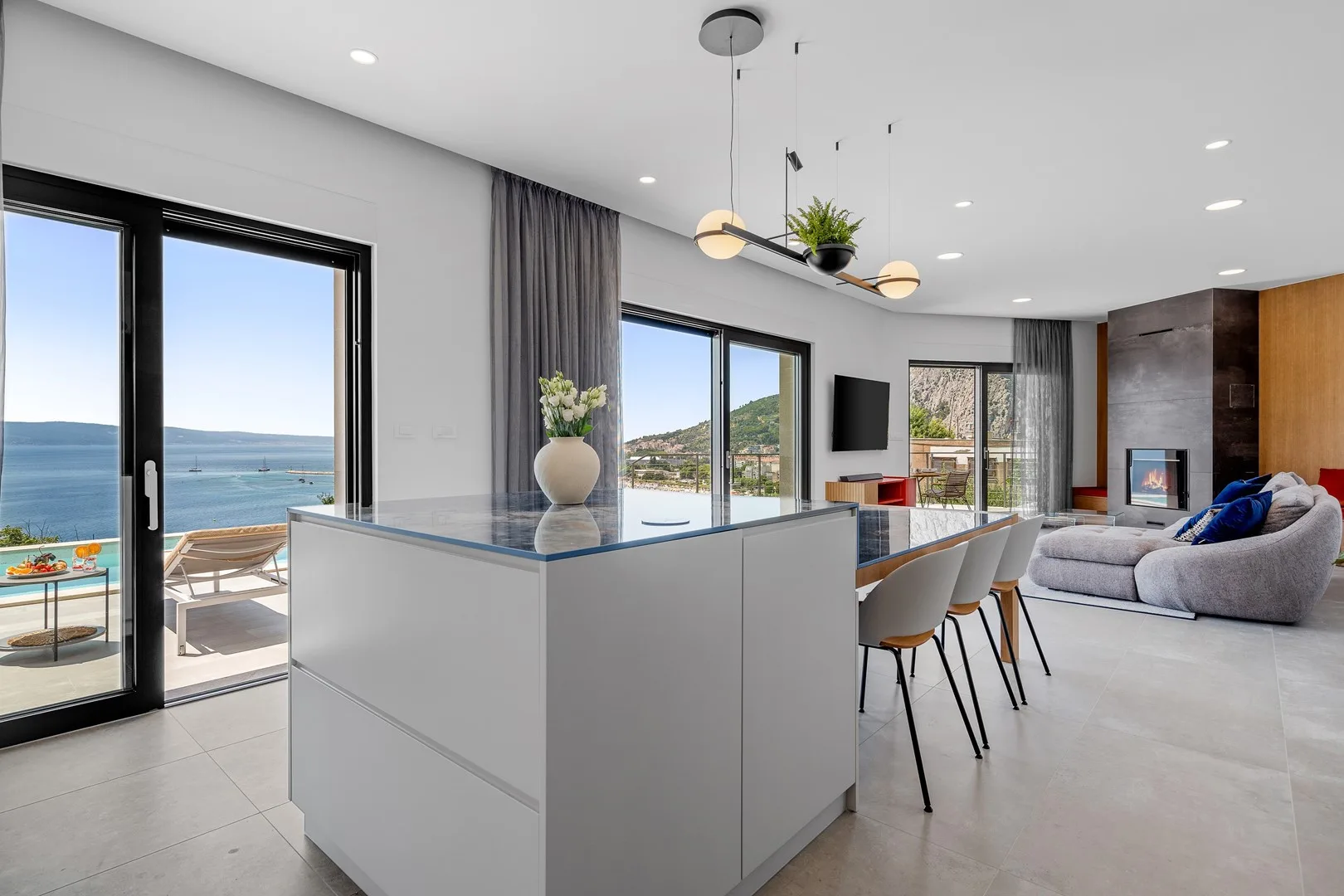 An open-plan kitchen and living area with a dining counter overlooking the water.