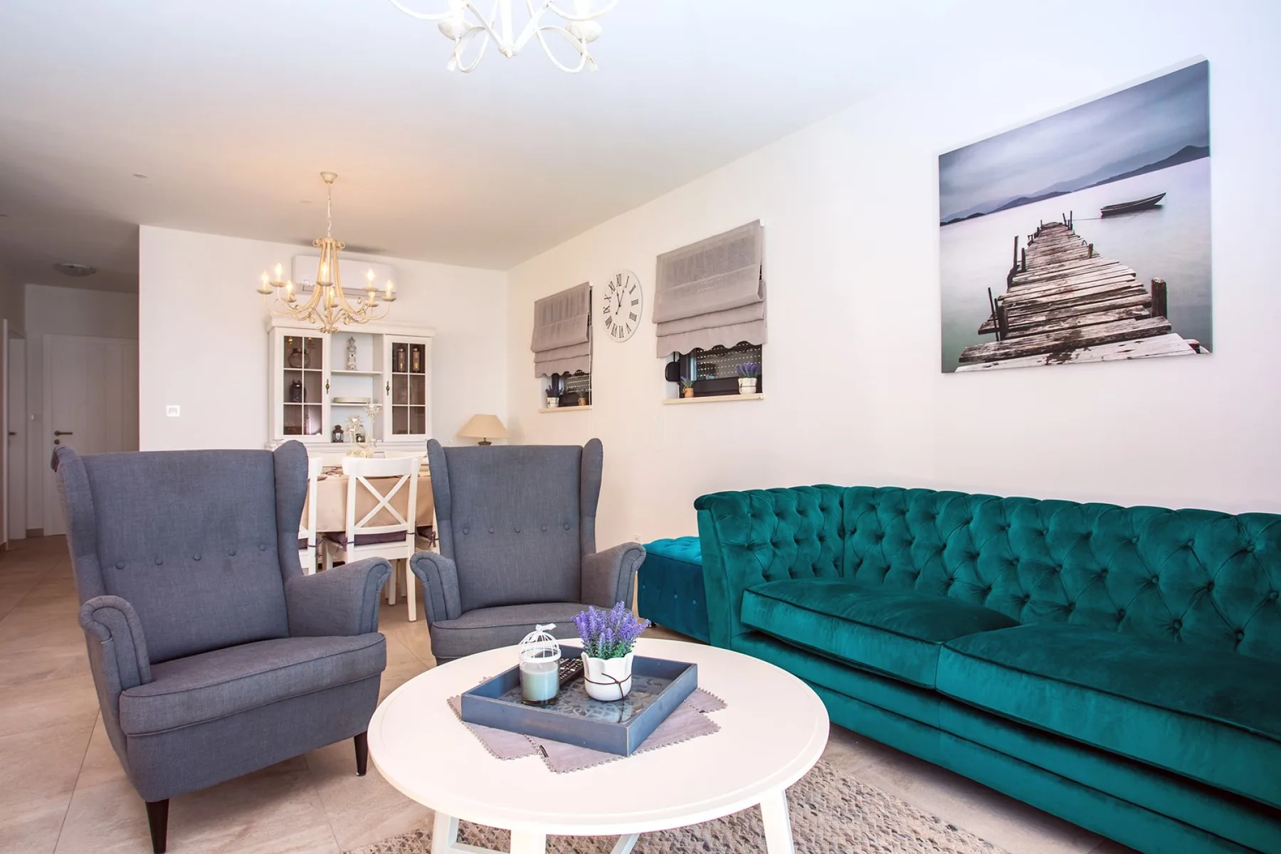 A living room with blue seating and a white coffee table.
