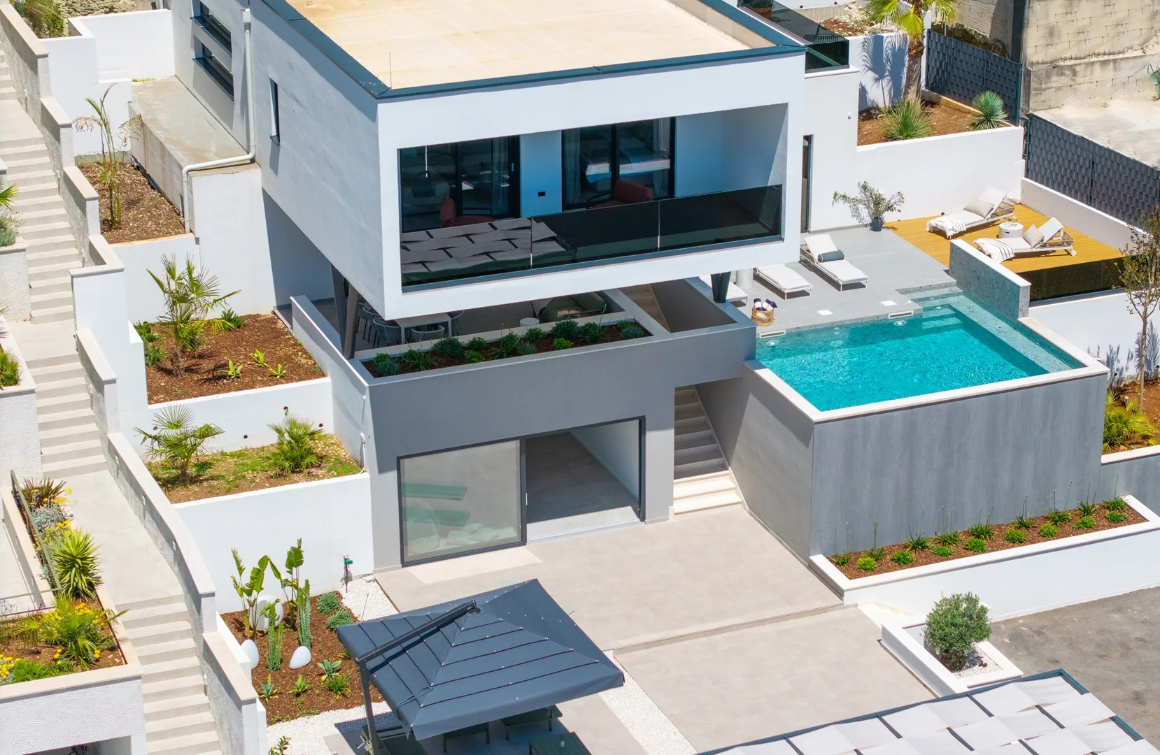 A modern house with a swimming pool and outdoor seating.