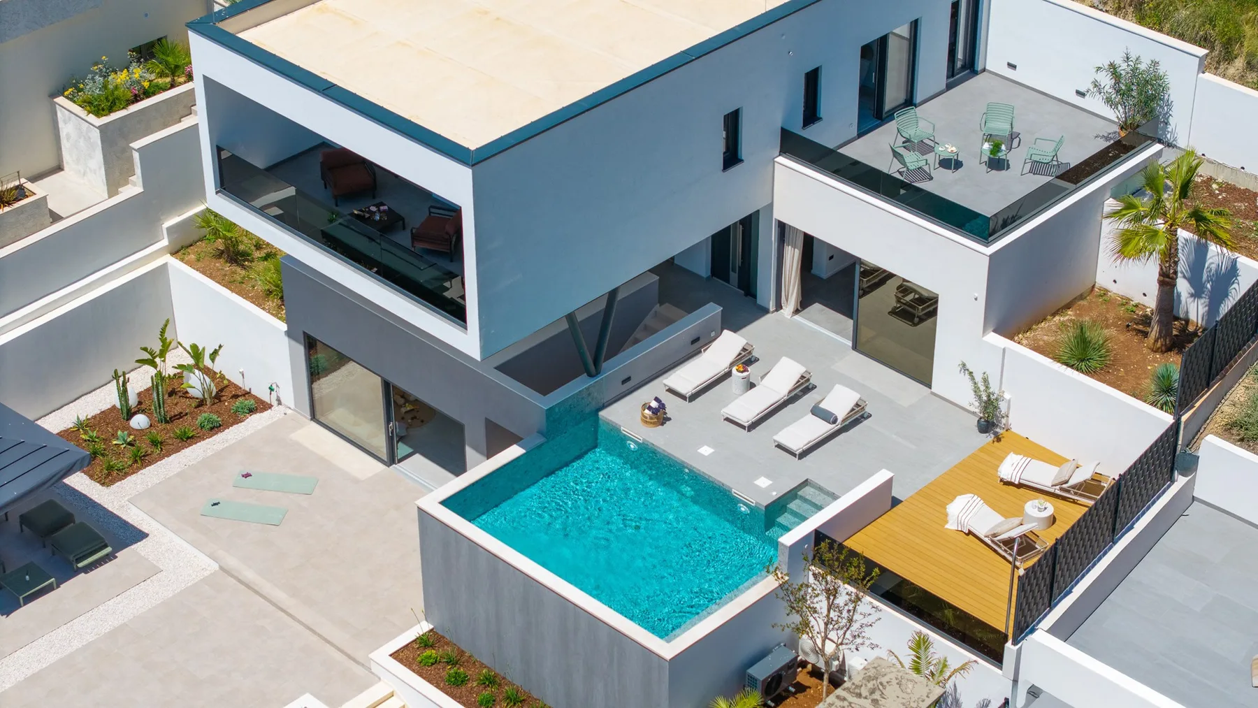 A modern house with a swimming pool and outdoor seating areas.