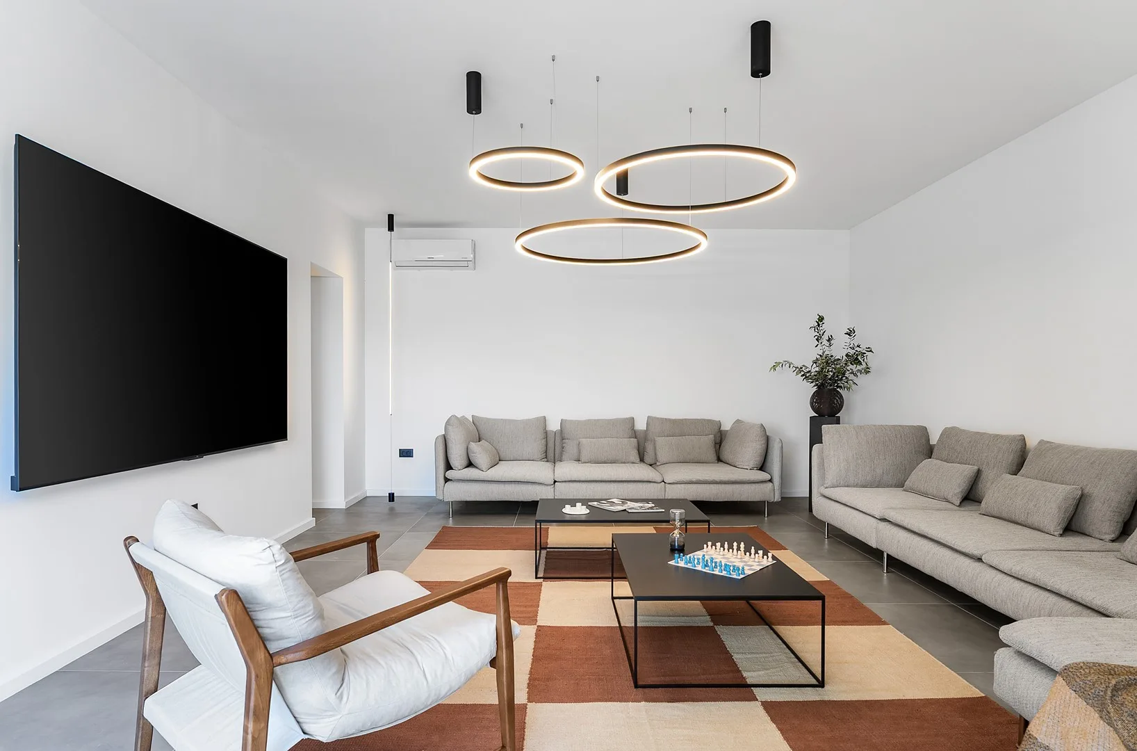 A bright living room with seating arranged around a low coffee table.