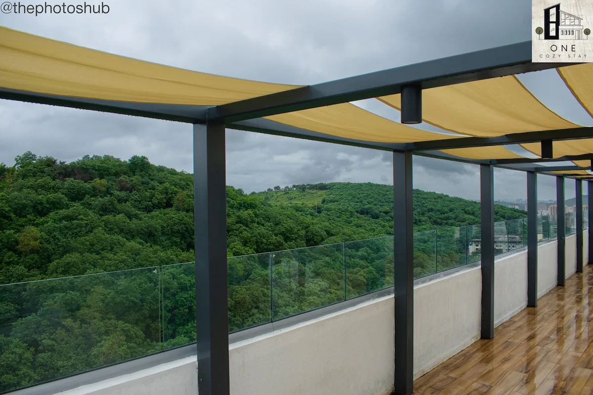 Zona común: Una terraza exterior cubierta ofrece vistas a un paisaje verde y boscoso.