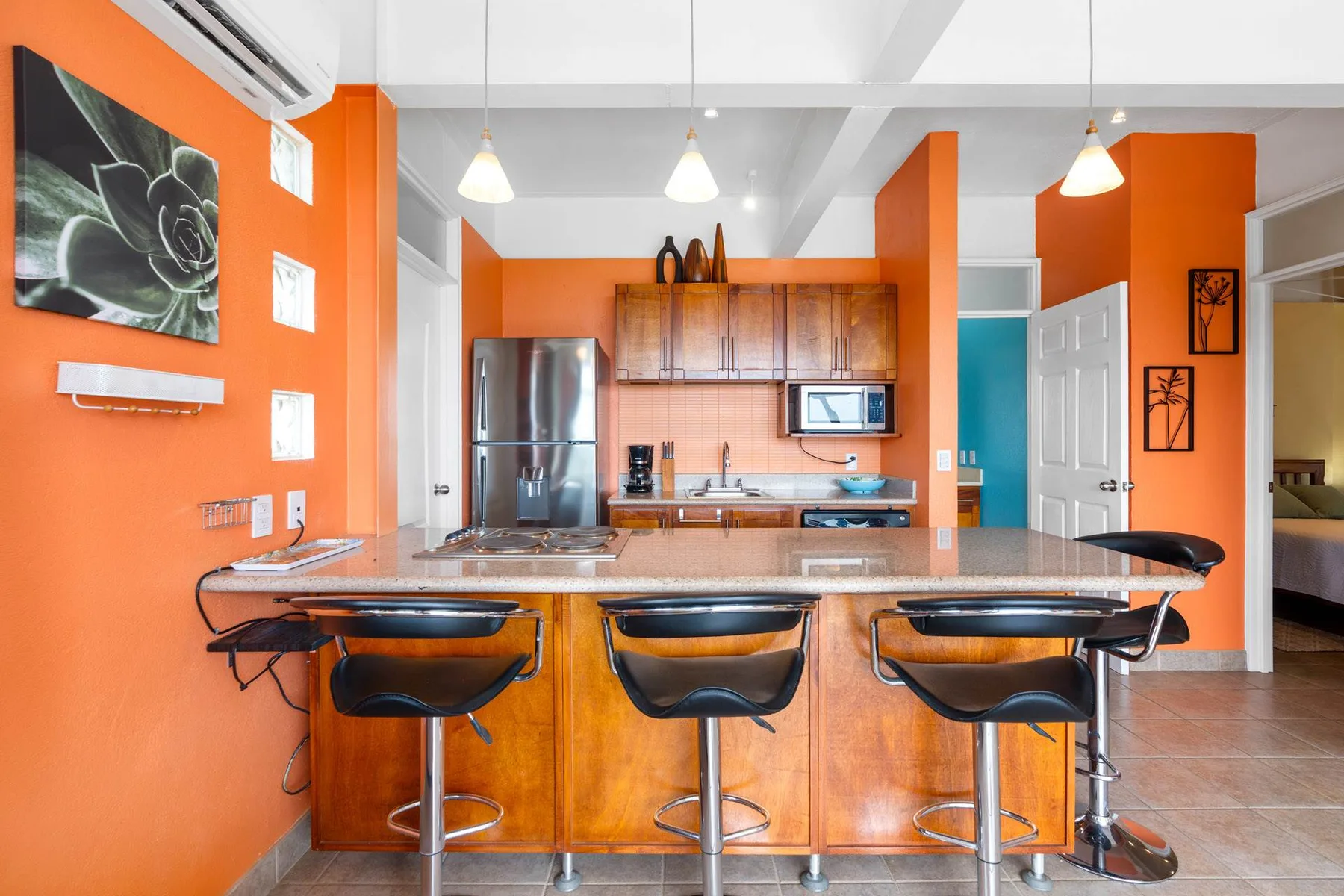 An open kitchen with an island counter and bar seating.