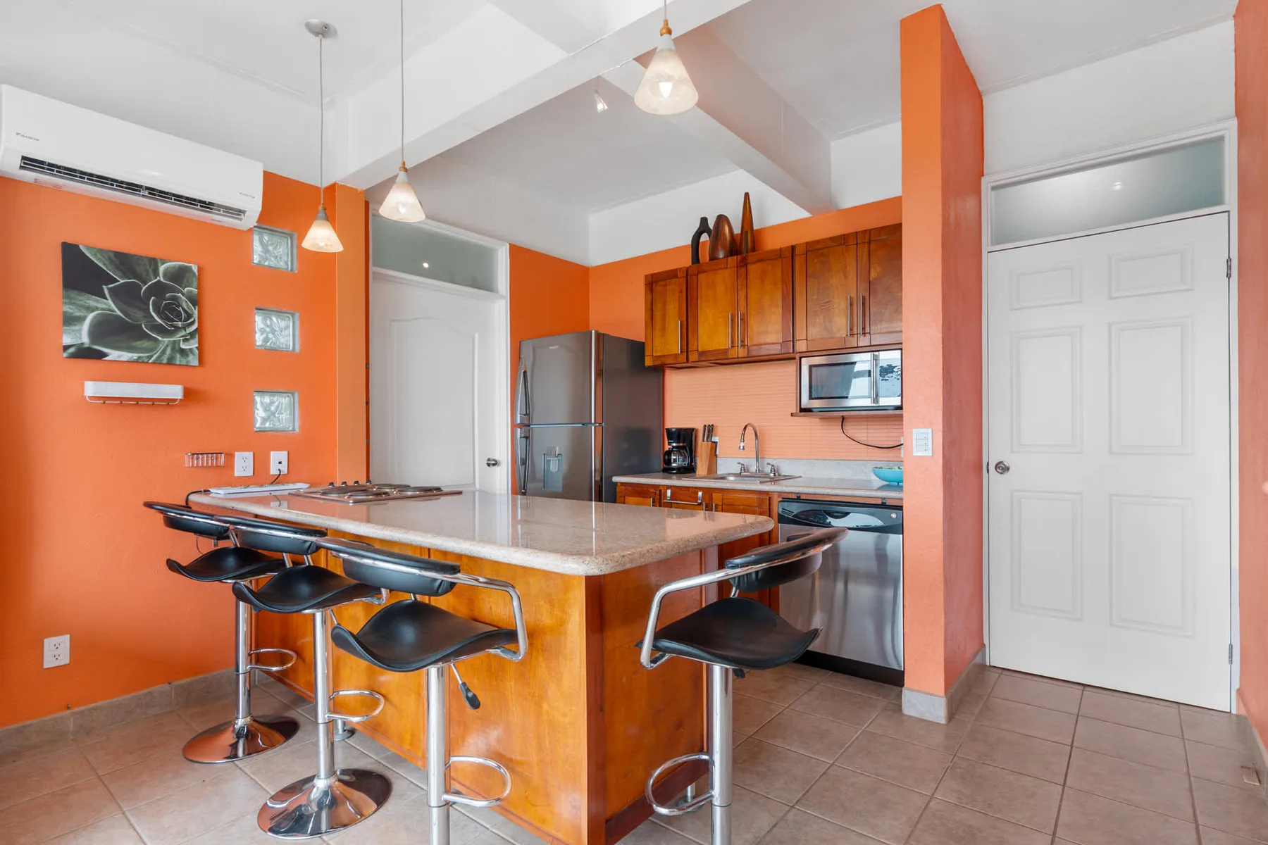 An open kitchen with a large island and bar seating.
