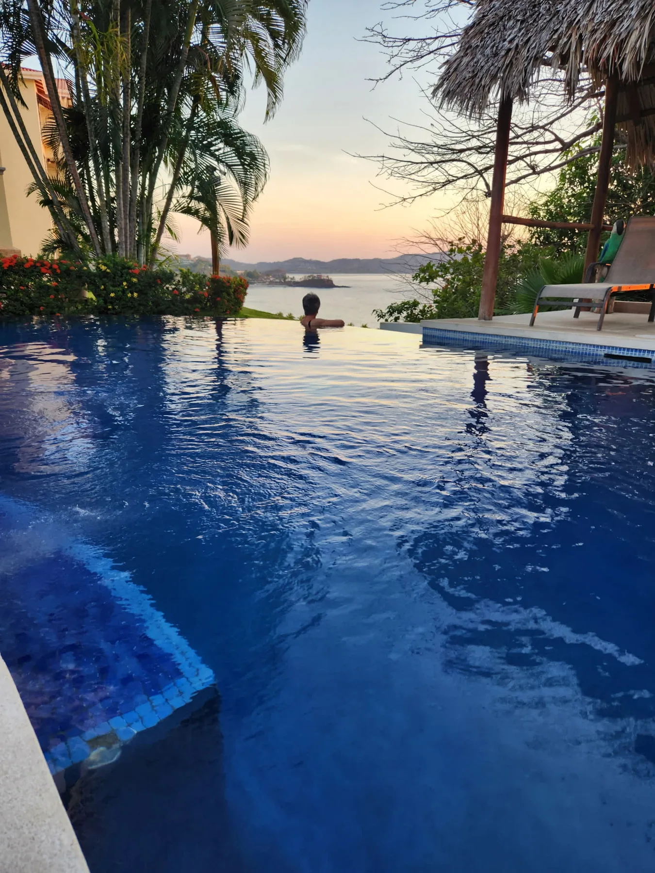 Shared amenity: An outdoor swimming pool overlooks the water at sunset.