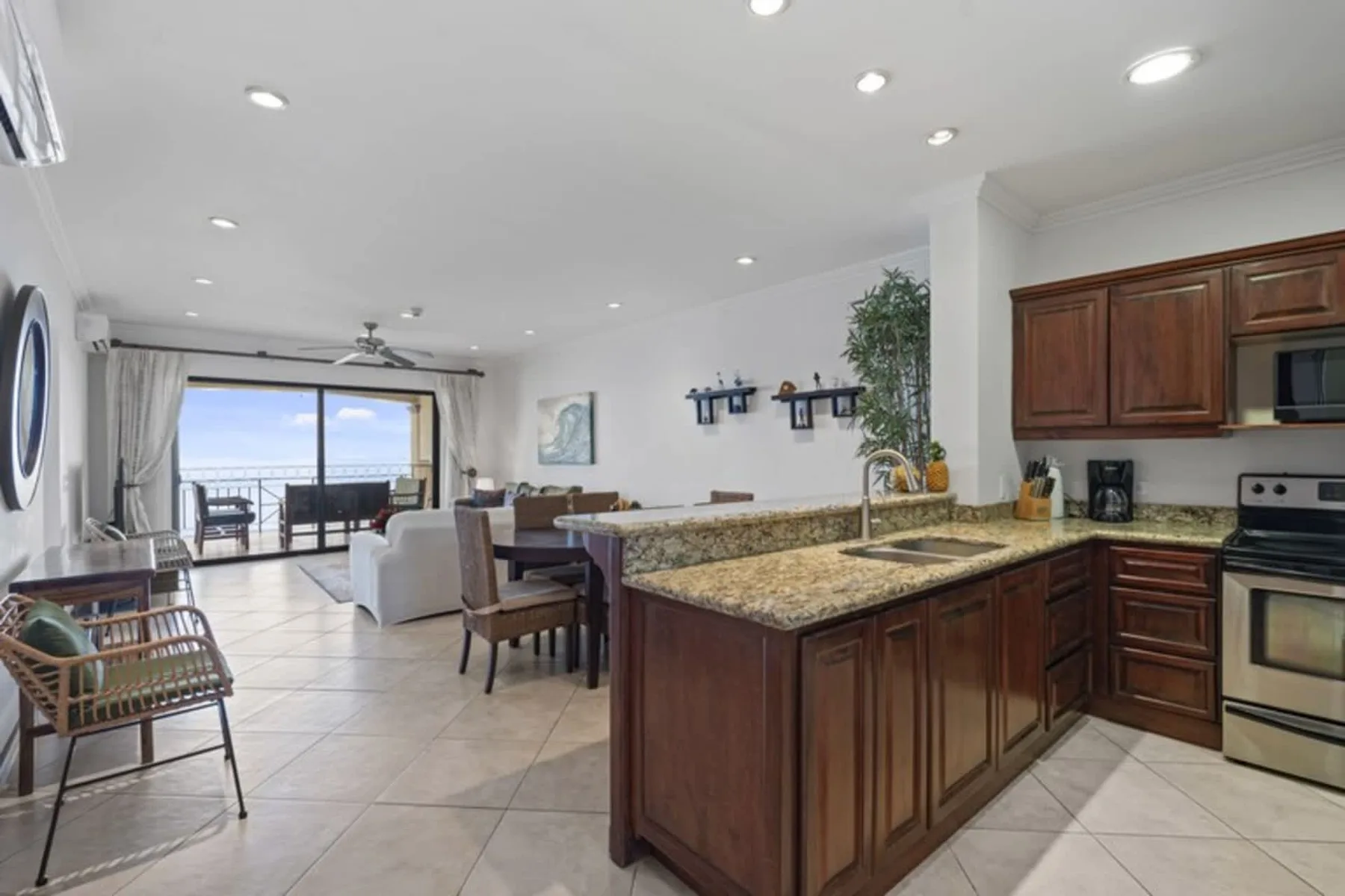 An open-plan kitchen and dining area with a large island and seating by the window.