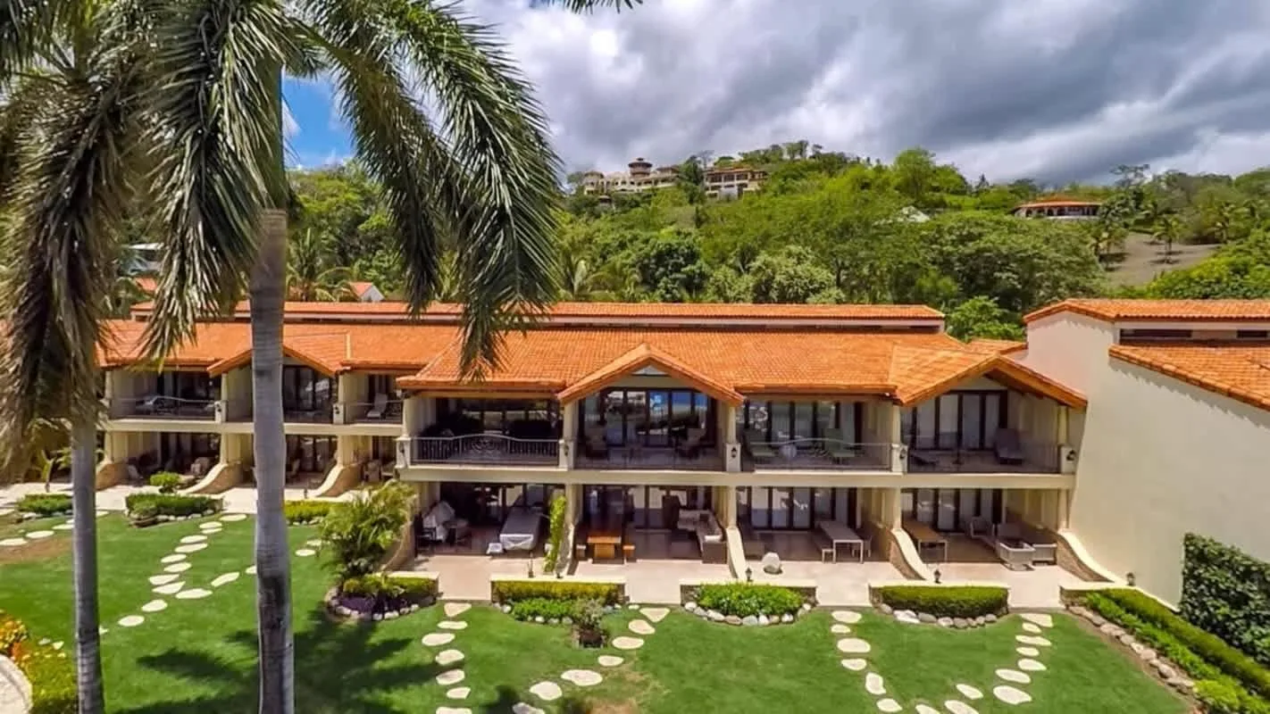 Shared amenity: A two-story building with orange roofs faces a landscaped lawn.