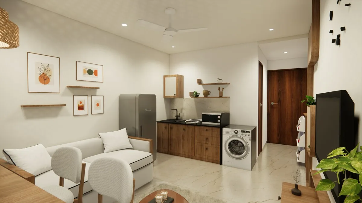 Una luminosa sala de estar con asientos, cuadros enmarcados y una cocina pequeña.