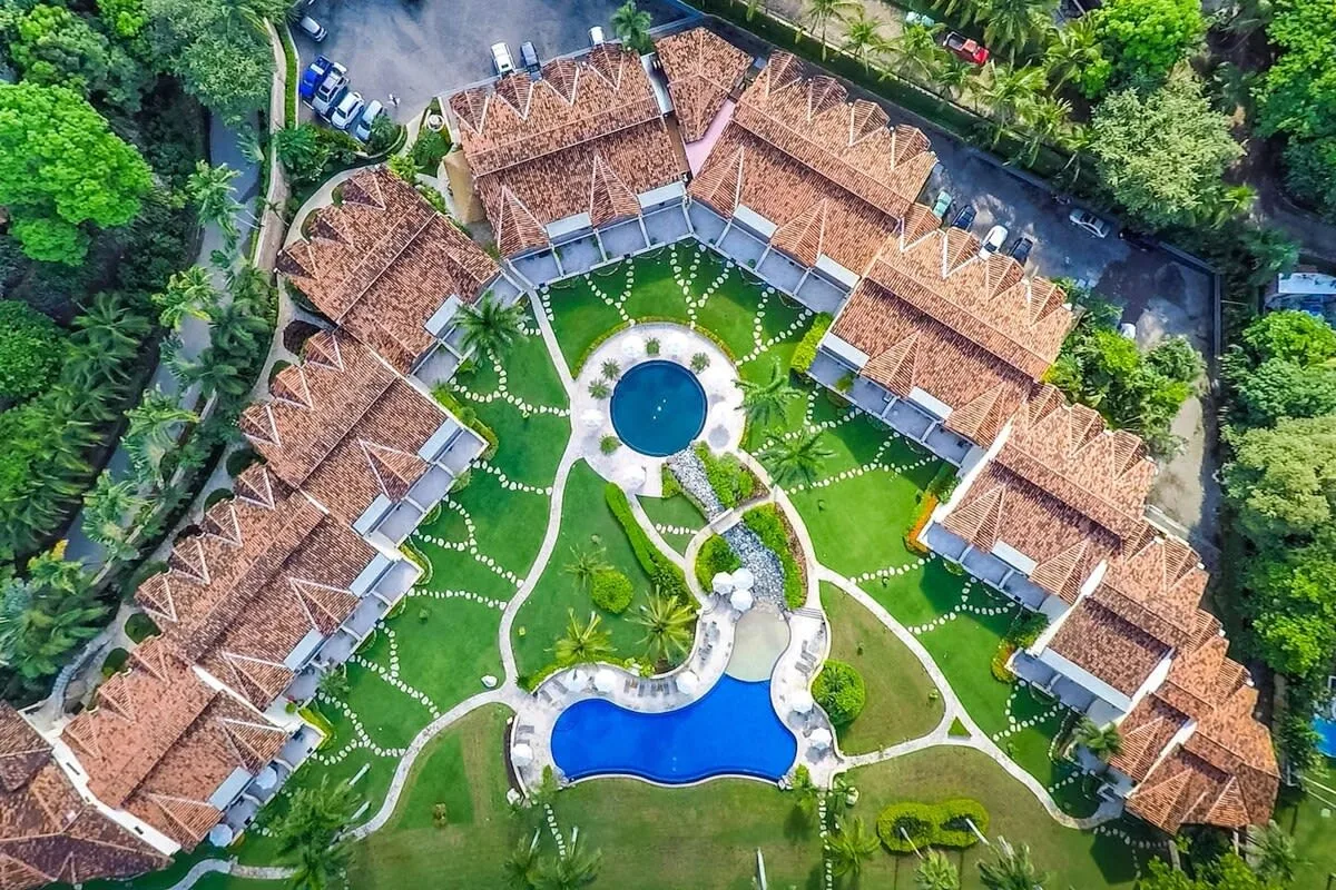 Shared amenity: An aerial view of buildings arranged around landscaped gardens and pools.