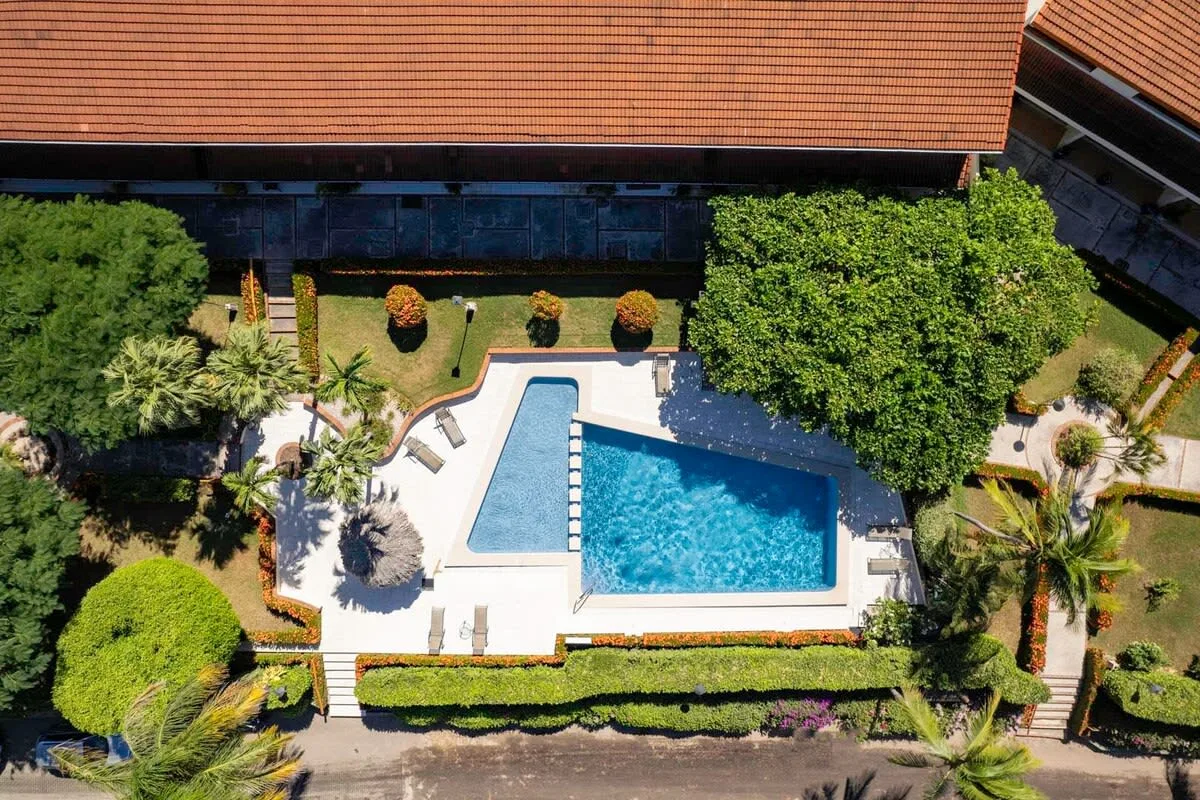 Shared amenity: An outdoor swimming pool sits among landscaped gardens and surrounding buildings.