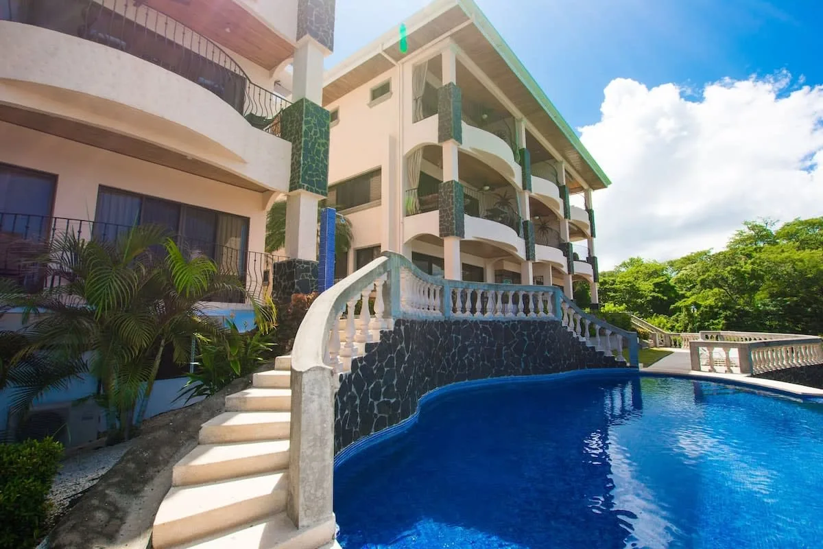 Shared amenity: A swimming pool beside a multi-story building with curved balconies.