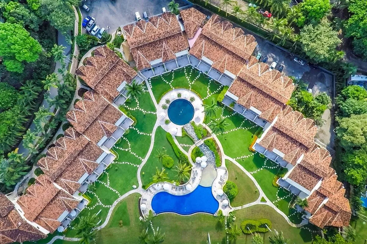 Shared amenity: An aerial view of buildings arranged around a landscaped courtyard with pools.