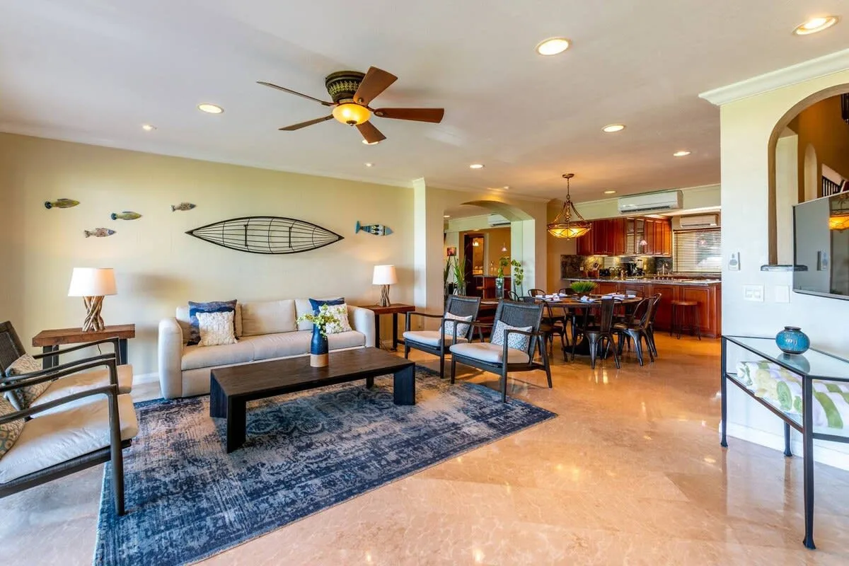 An open-plan living room and kitchen with a dining table and seating.