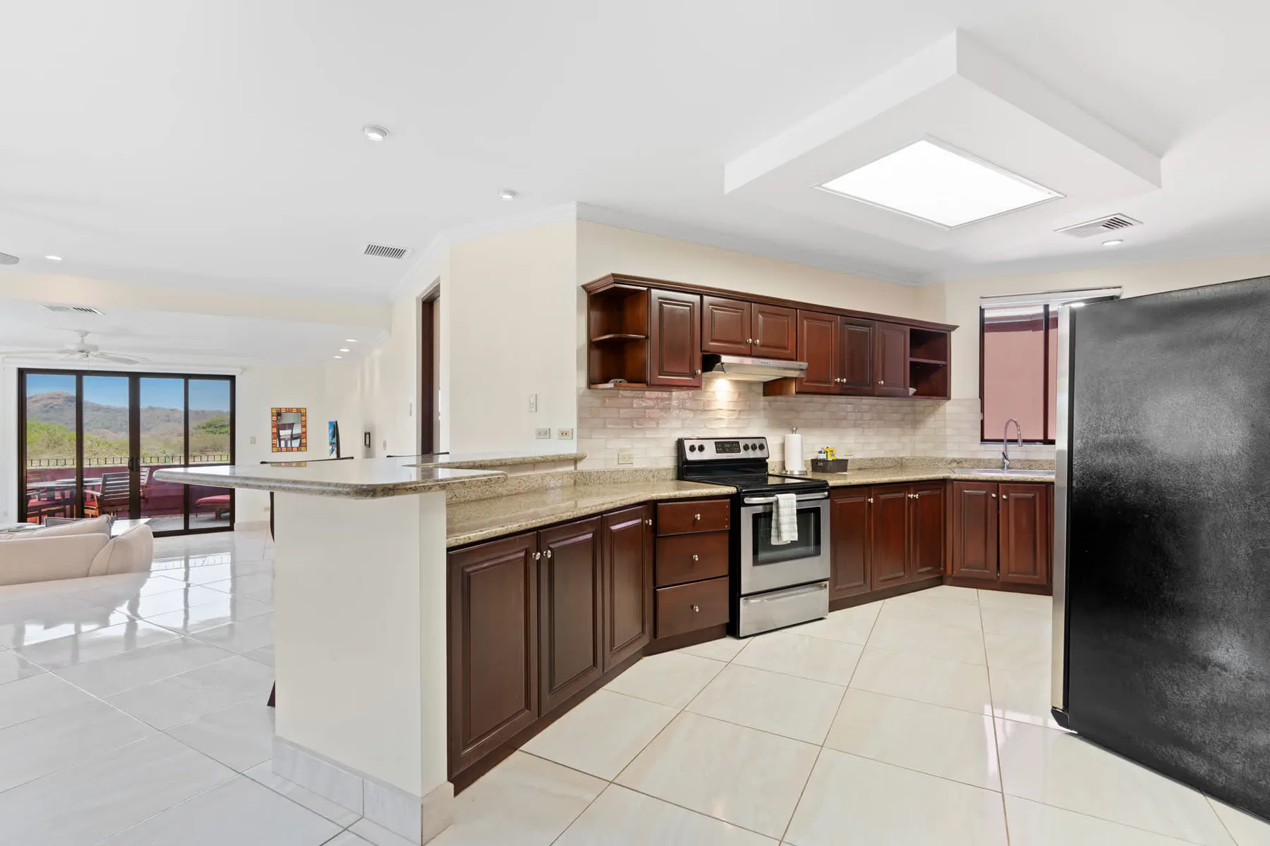 A bright kitchen with dark wood cabinets and a central island.
