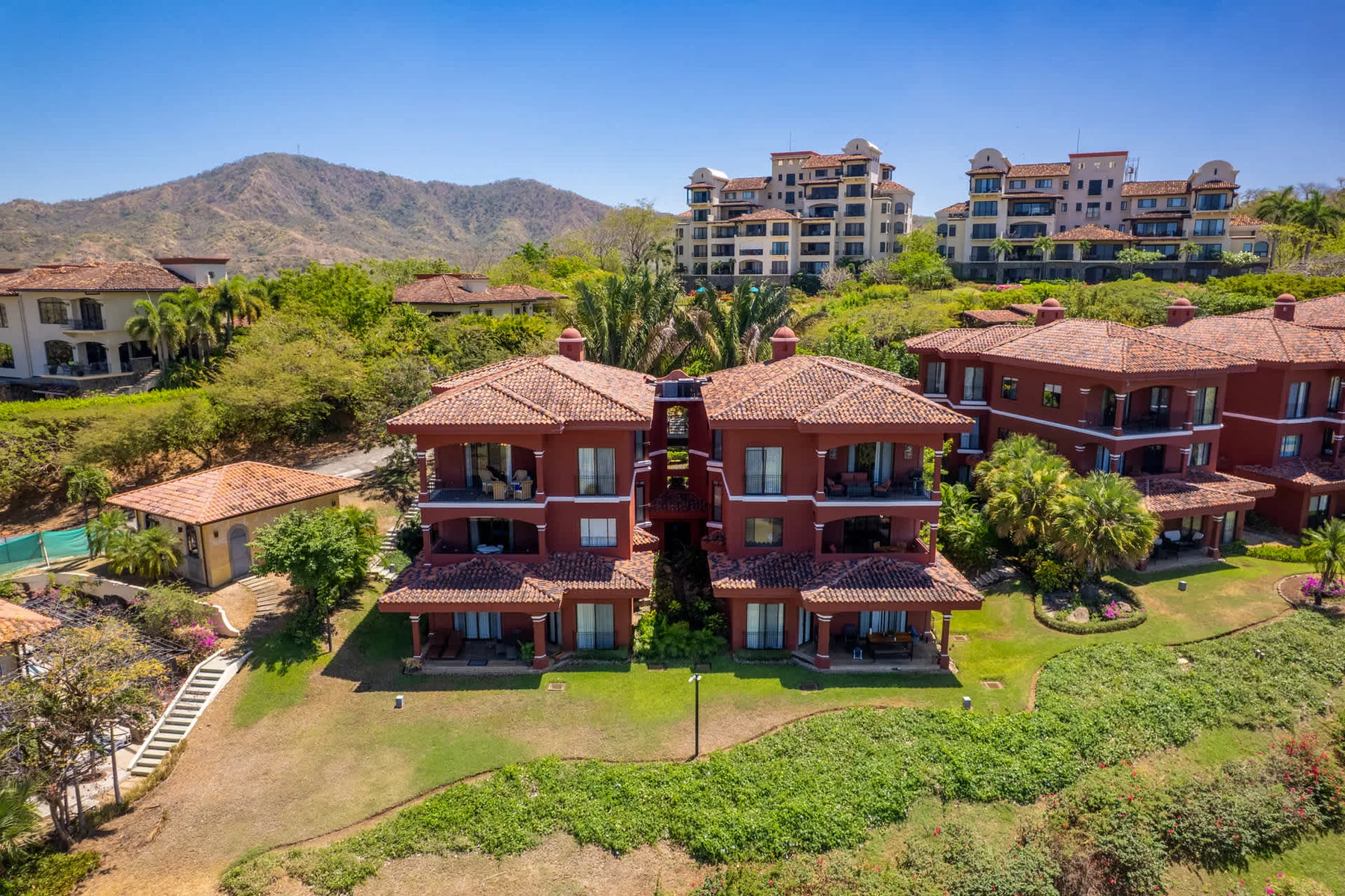 Shared amenity: Aerial view of red-roofed residential buildings surrounded by greenery.