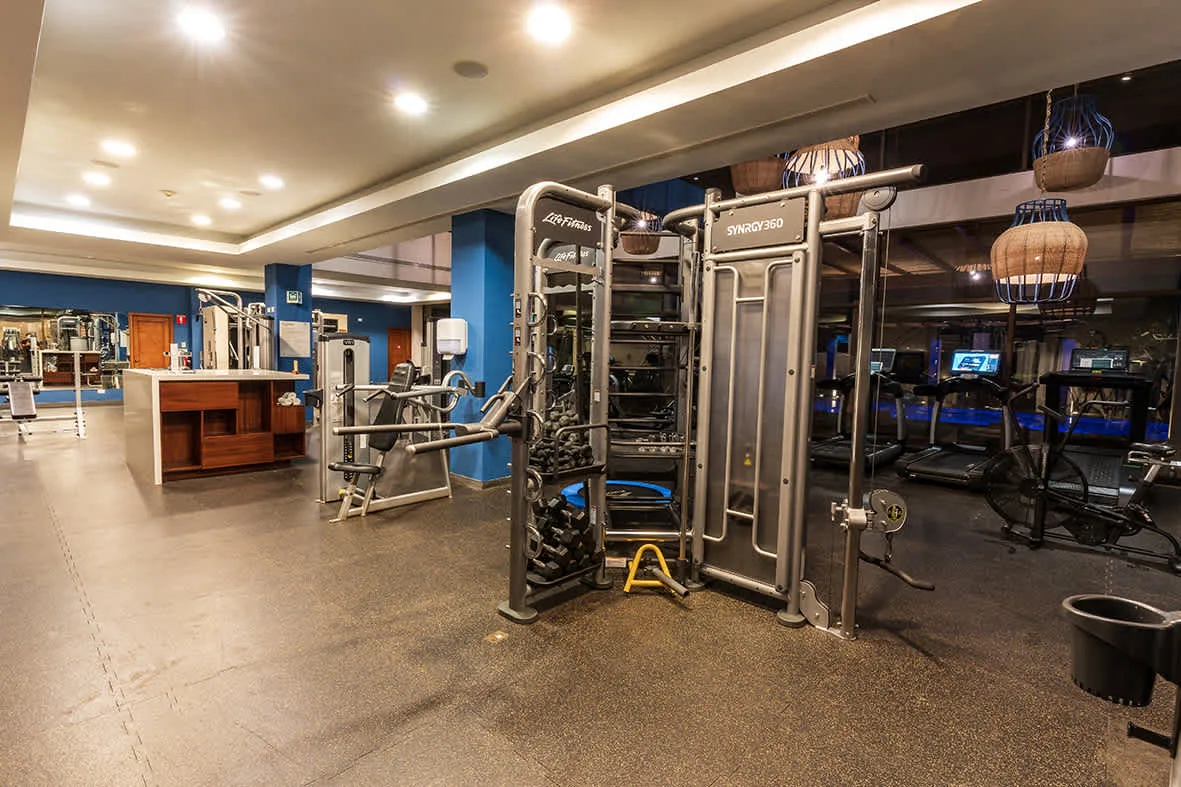 Shared amenity: A gym with exercise machines and workout equipment.