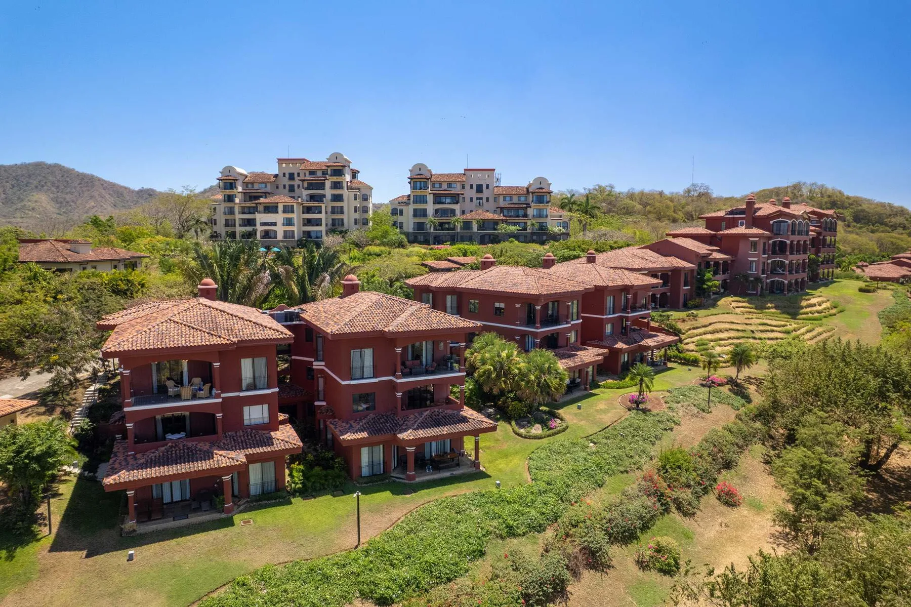 Shared amenity: Aerial view of red-roofed buildings set among landscaped grounds.