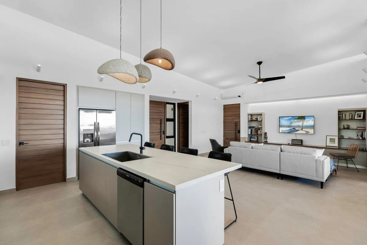 An open-plan kitchen and living area with a large island and seating.