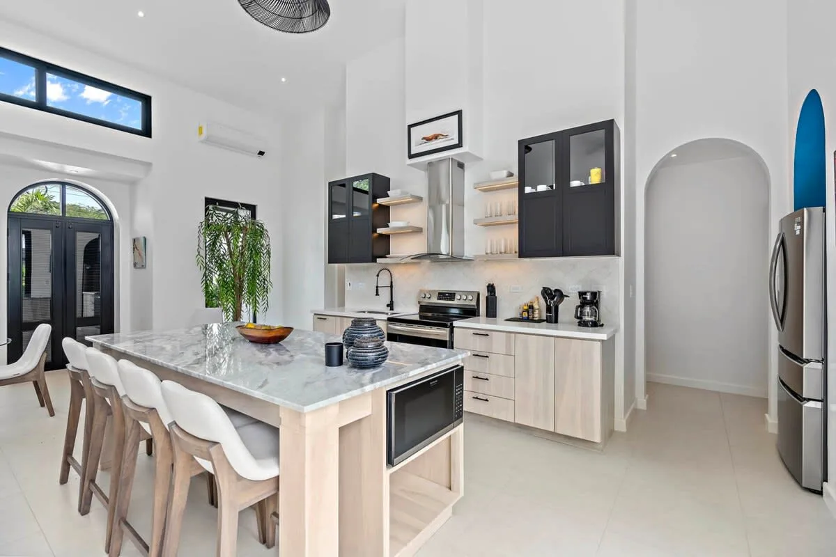 A bright kitchen with a large island and seating.