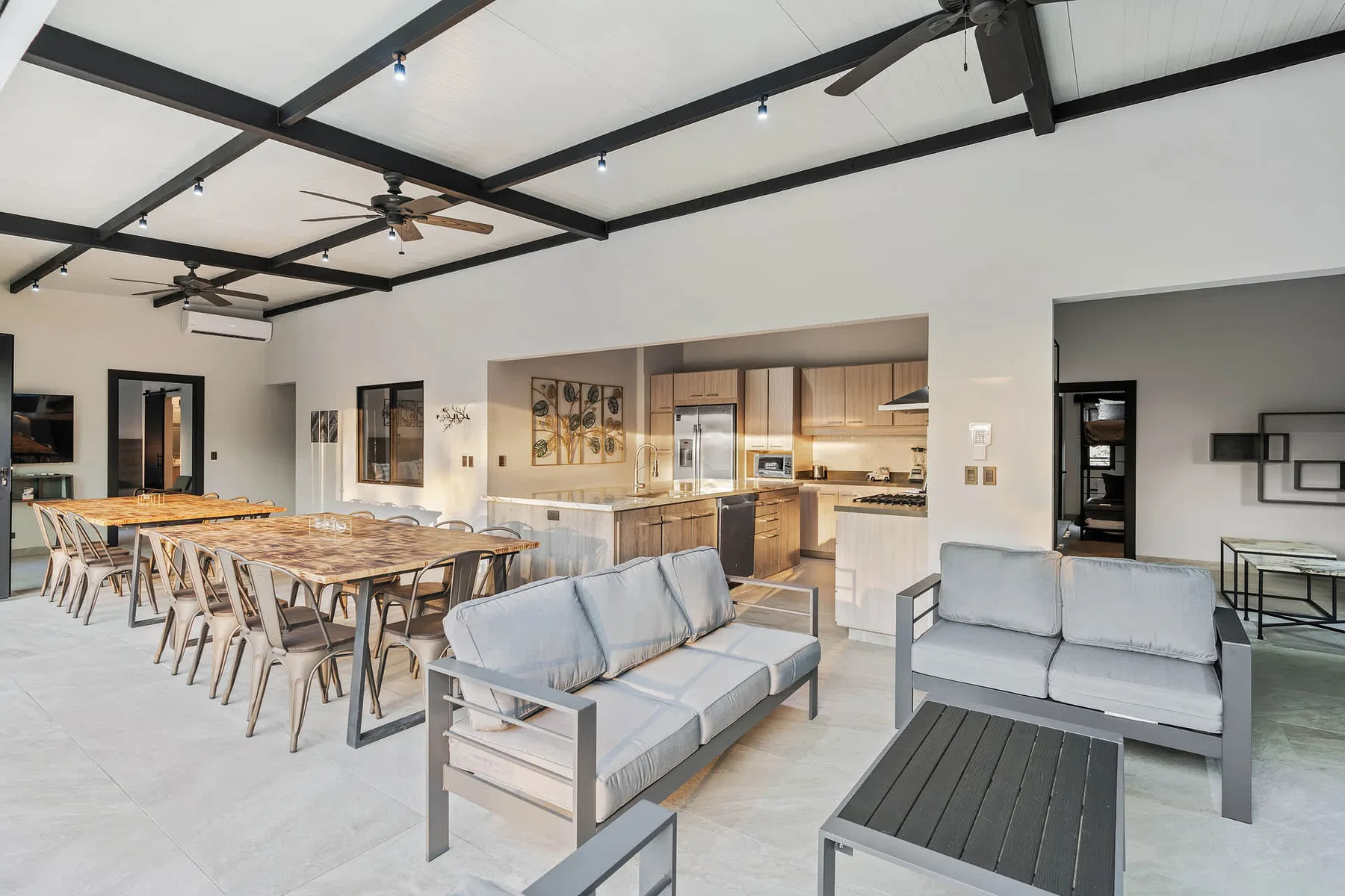 An open-plan living and dining area with a kitchen along the back wall.