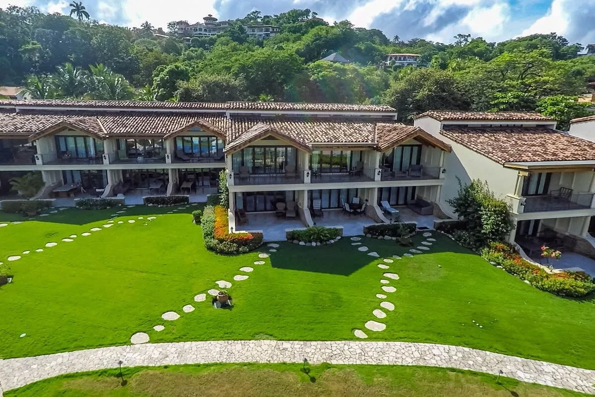 Shared amenity: A multi-unit building overlooks a green lawn with stepping-stone paths.