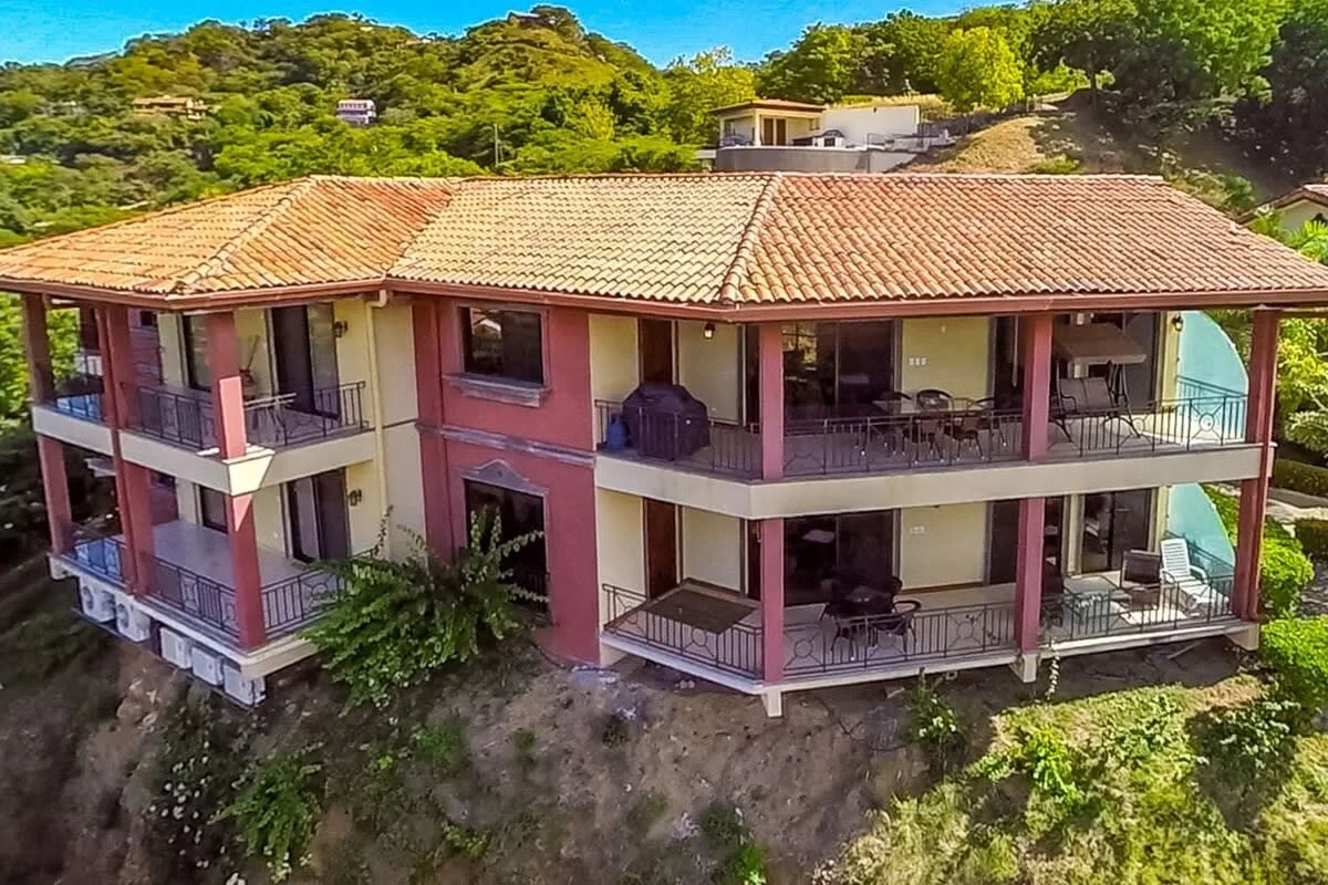Shared amenity: A multi-story building with balconies sits among green hills.