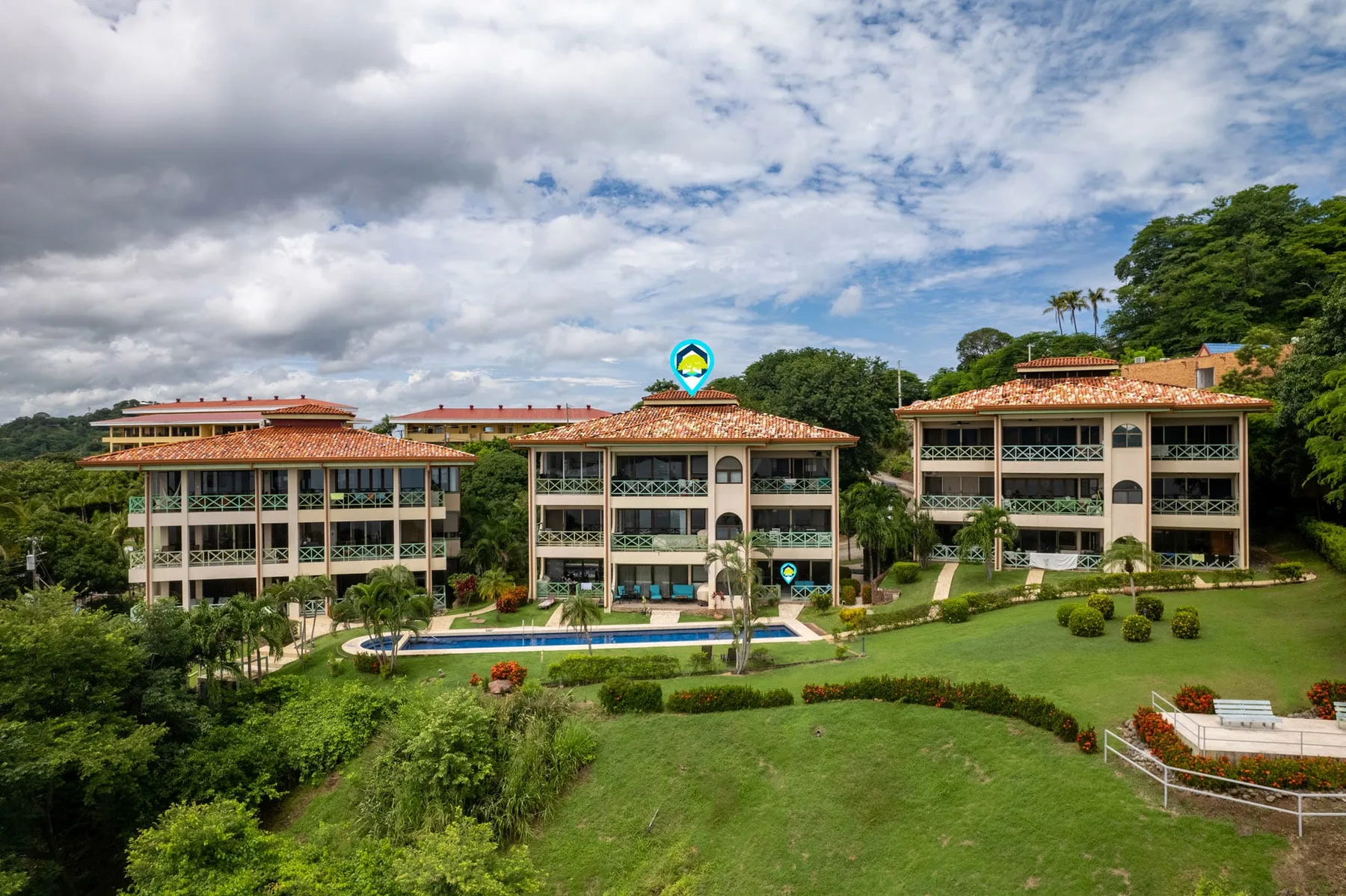 Shared amenity: Buildings overlook a landscaped lawn and outdoor swimming pool.