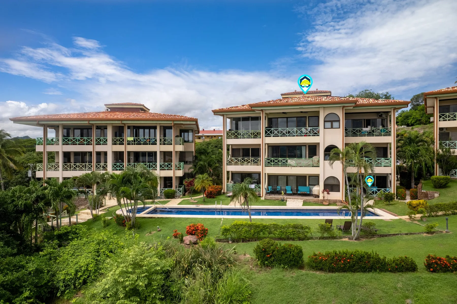 Shared amenity: Apartment buildings overlook a swimming pool and landscaped grounds.