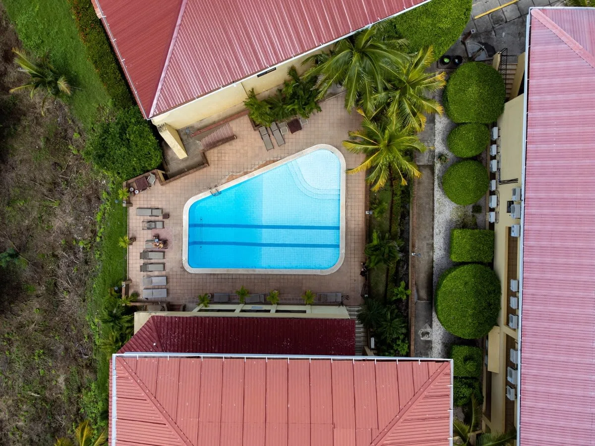 Zona común: Vista aérea de una piscina entre edificios, con tumbonas junto a la terraza.