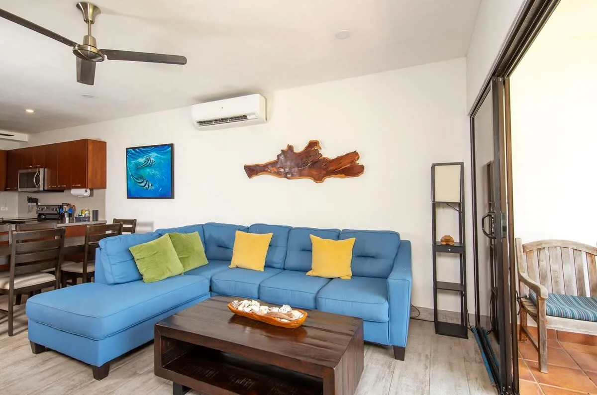 Living room with blue sectional seating and a coffee table.