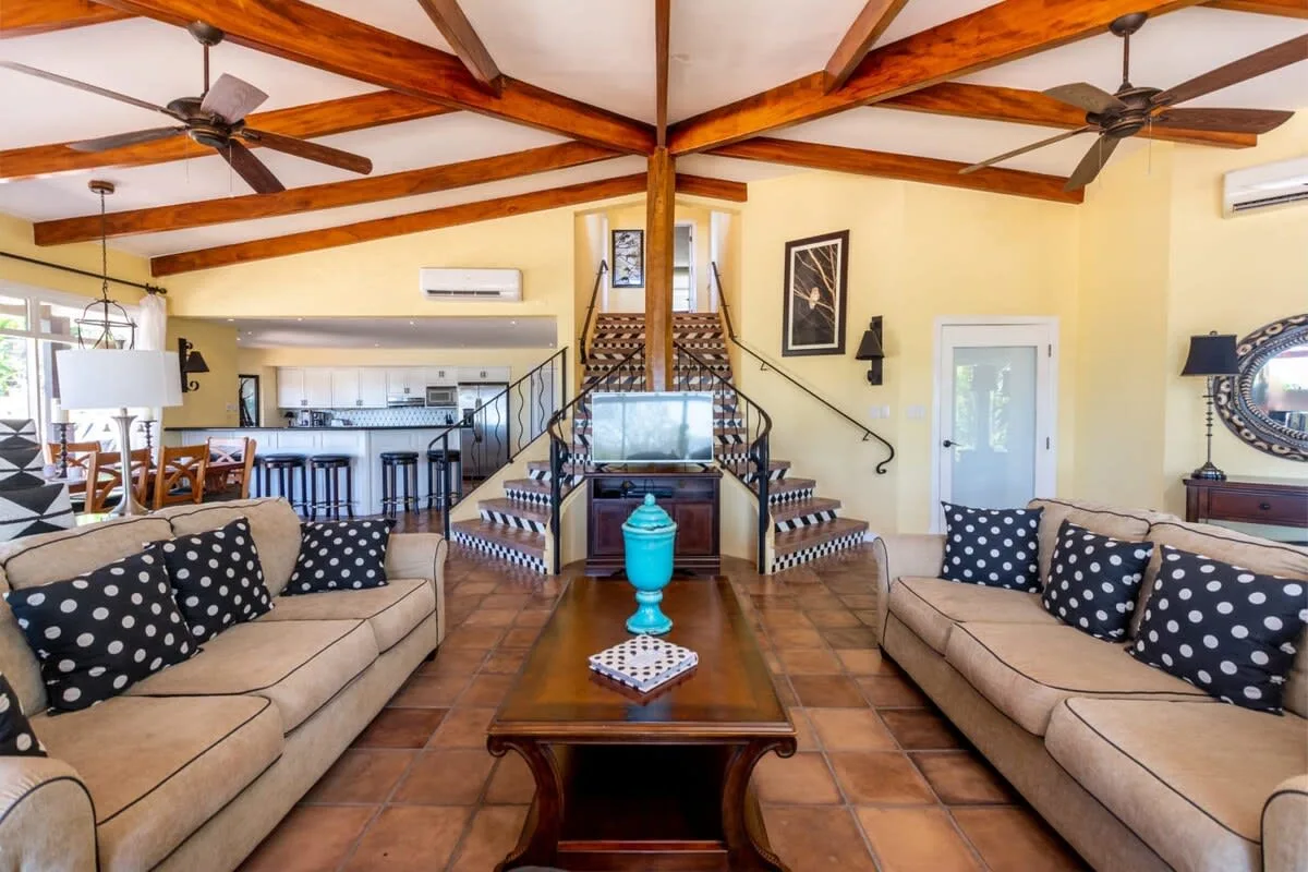 A living room with matching seating arranged around a wooden coffee table.