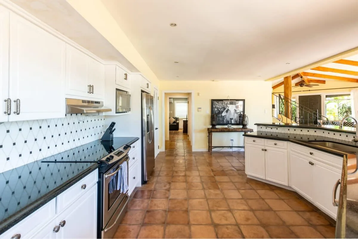 A bright kitchen with white cabinetry and a central island.