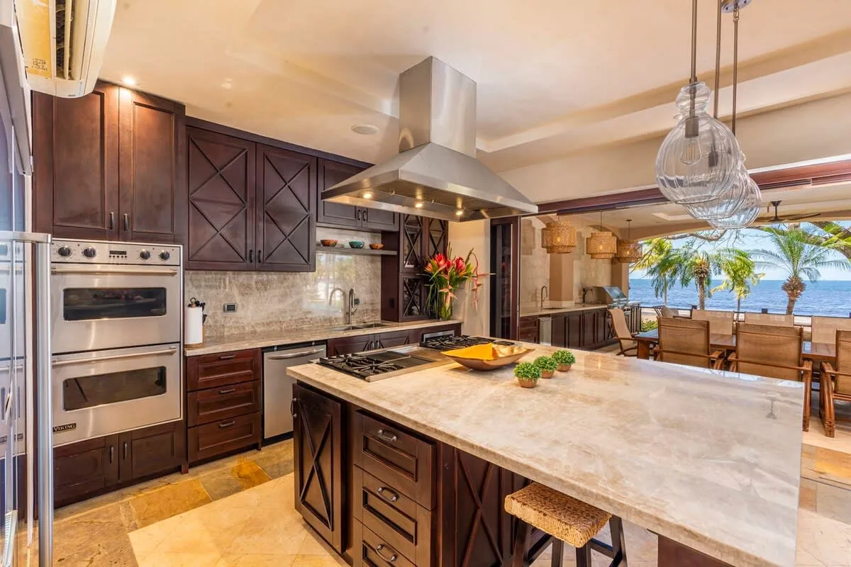 A spacious kitchen features dark cabinetry and a large central island.