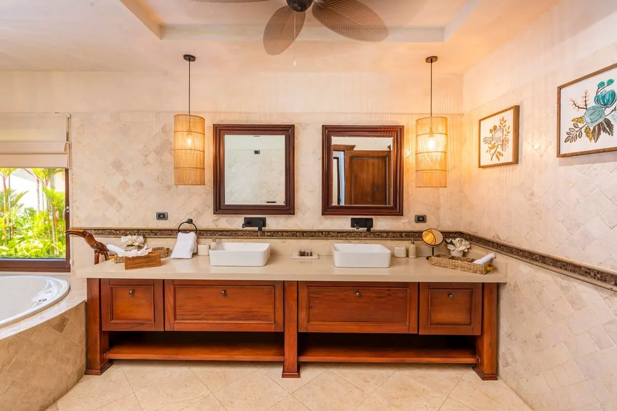A bathroom vanity with two sinks and framed mirrors.