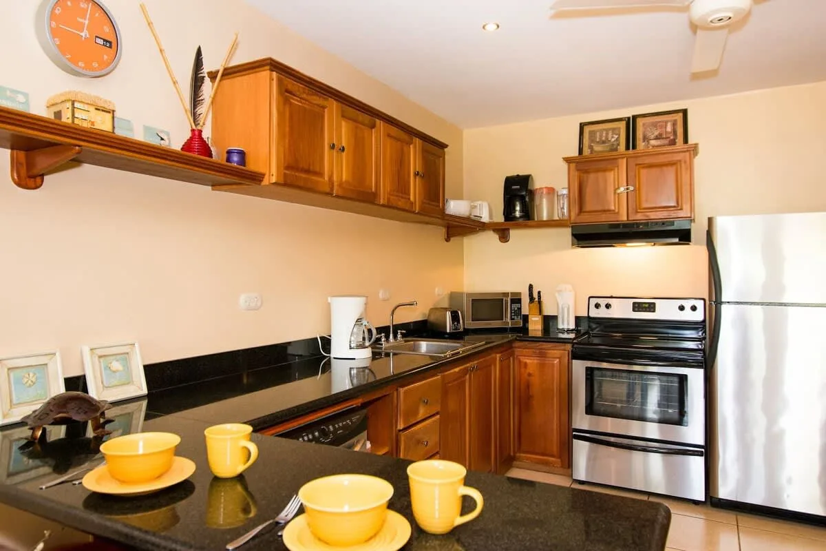 A kitchen with wooden cabinets, a stove, and a countertop.