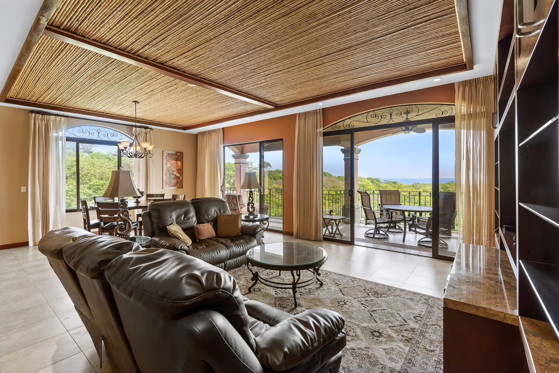 A living room with seating and glass doors opening onto a patio.