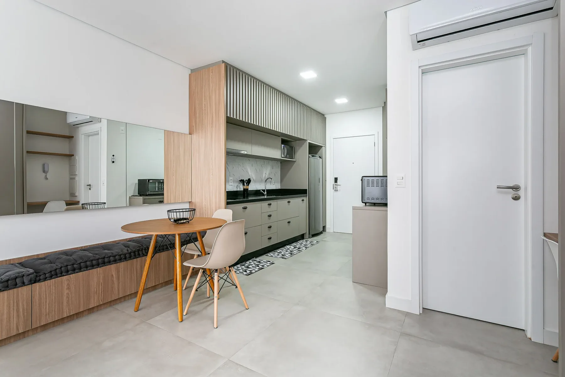 A modern kitchen and dining area with a table beside the counters.
