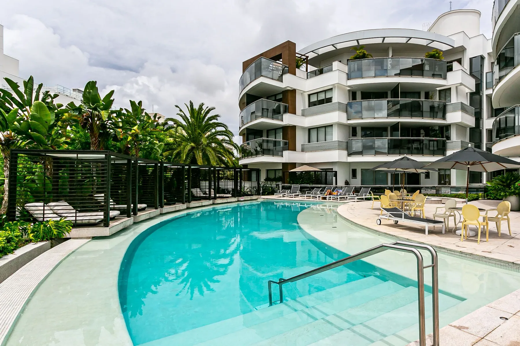 Shared amenity: An outdoor swimming pool beside a modern multi-story building.