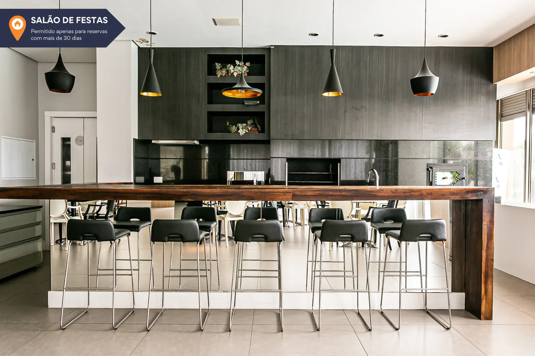 Shared amenity: A communal kitchen and counter with bar seating.