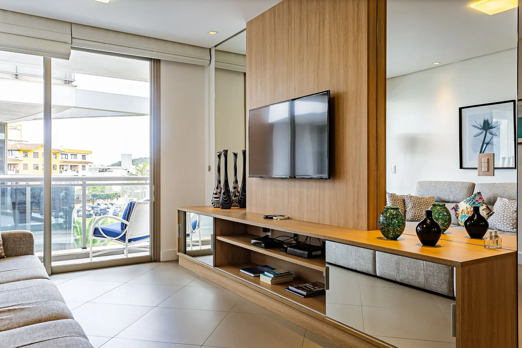 A living room with a television mounted on a wood-paneled wall.