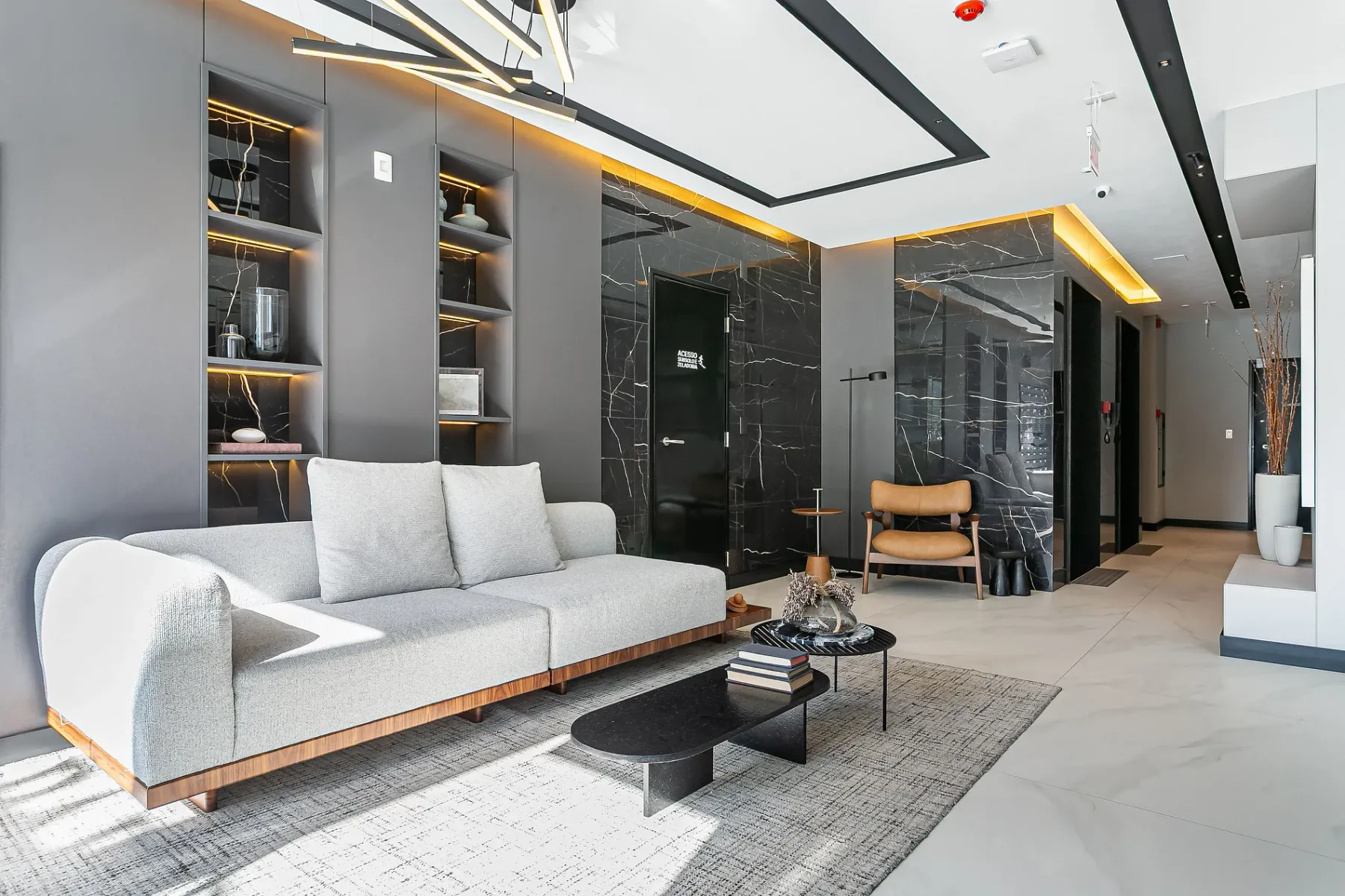 Shared amenity: A modern lounge with seating, a coffee table, and built-in shelving.