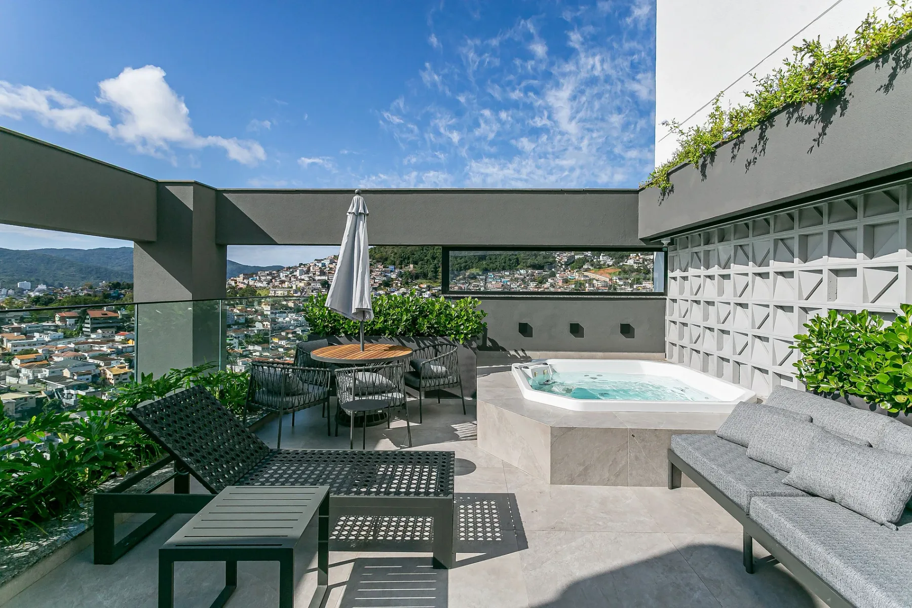Shared amenity: A rooftop terrace has outdoor seating and a raised hot tub.