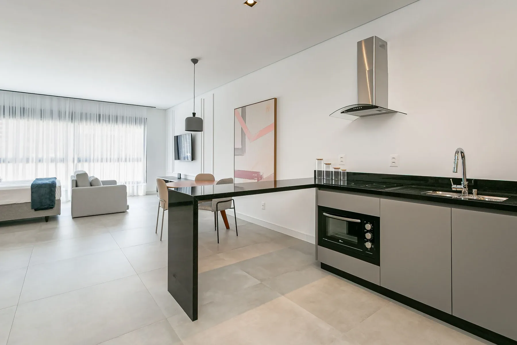A bright open-plan kitchen and living area with a breakfast bar.