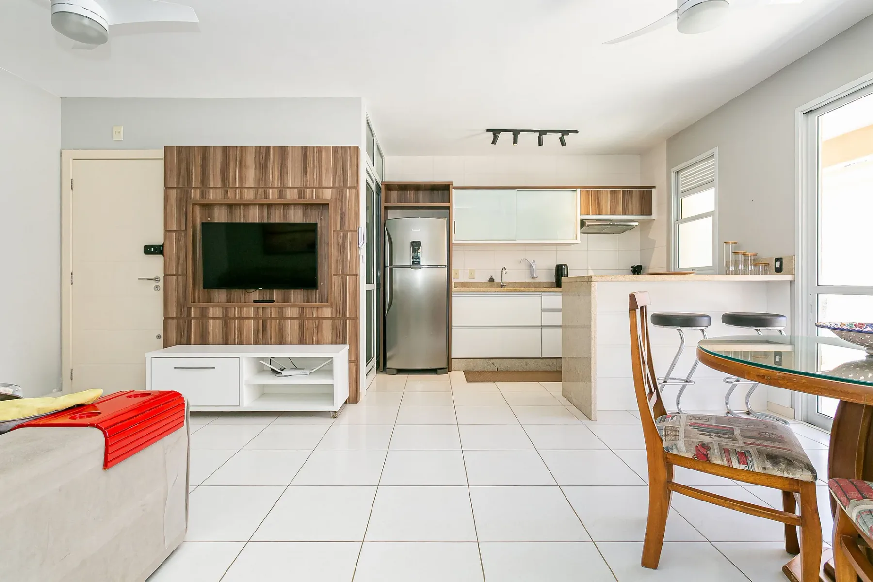 A bright open-plan living and kitchen area with a dining table.