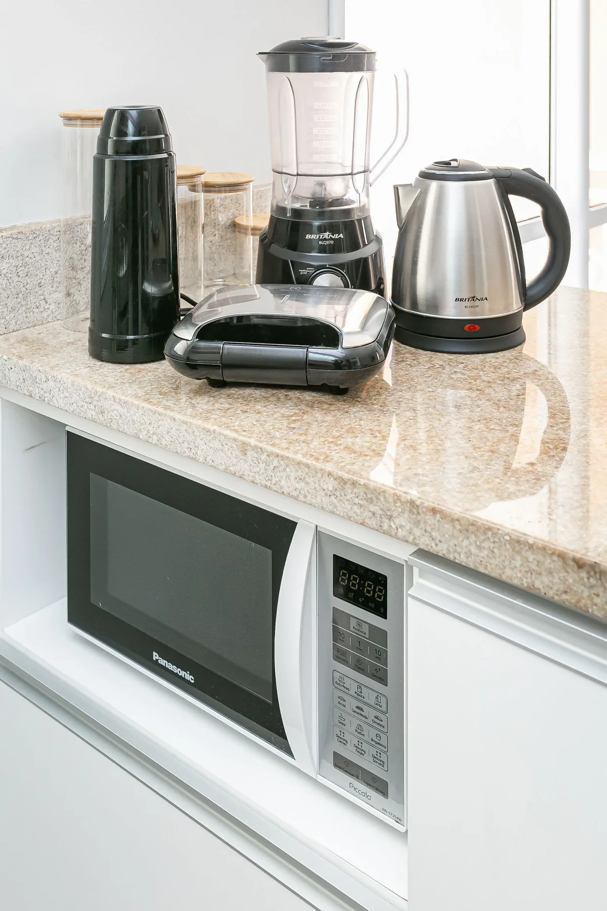 Kitchen counter with small appliances, including a blender and kettle.