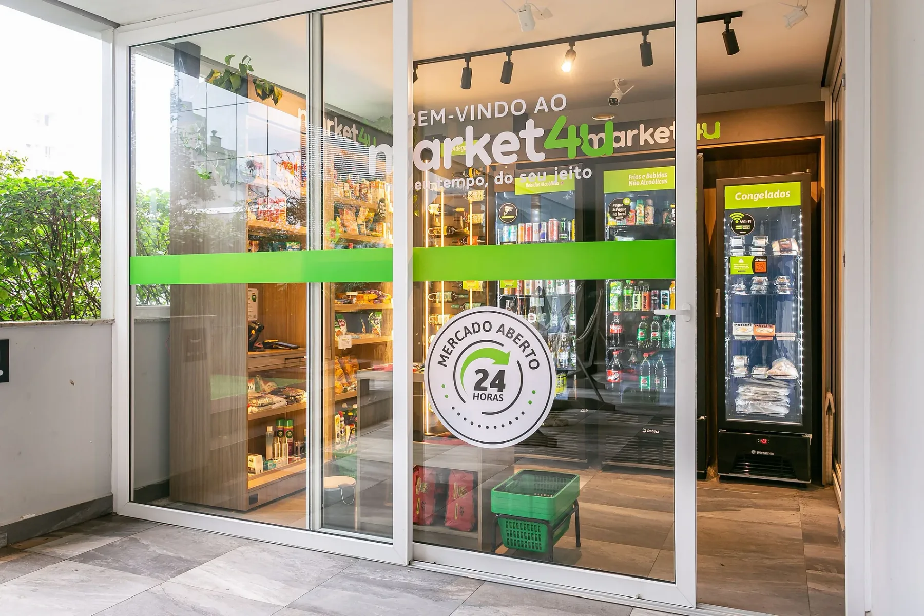Shared amenity: A convenience store entrance with glass doors and a green stripe.