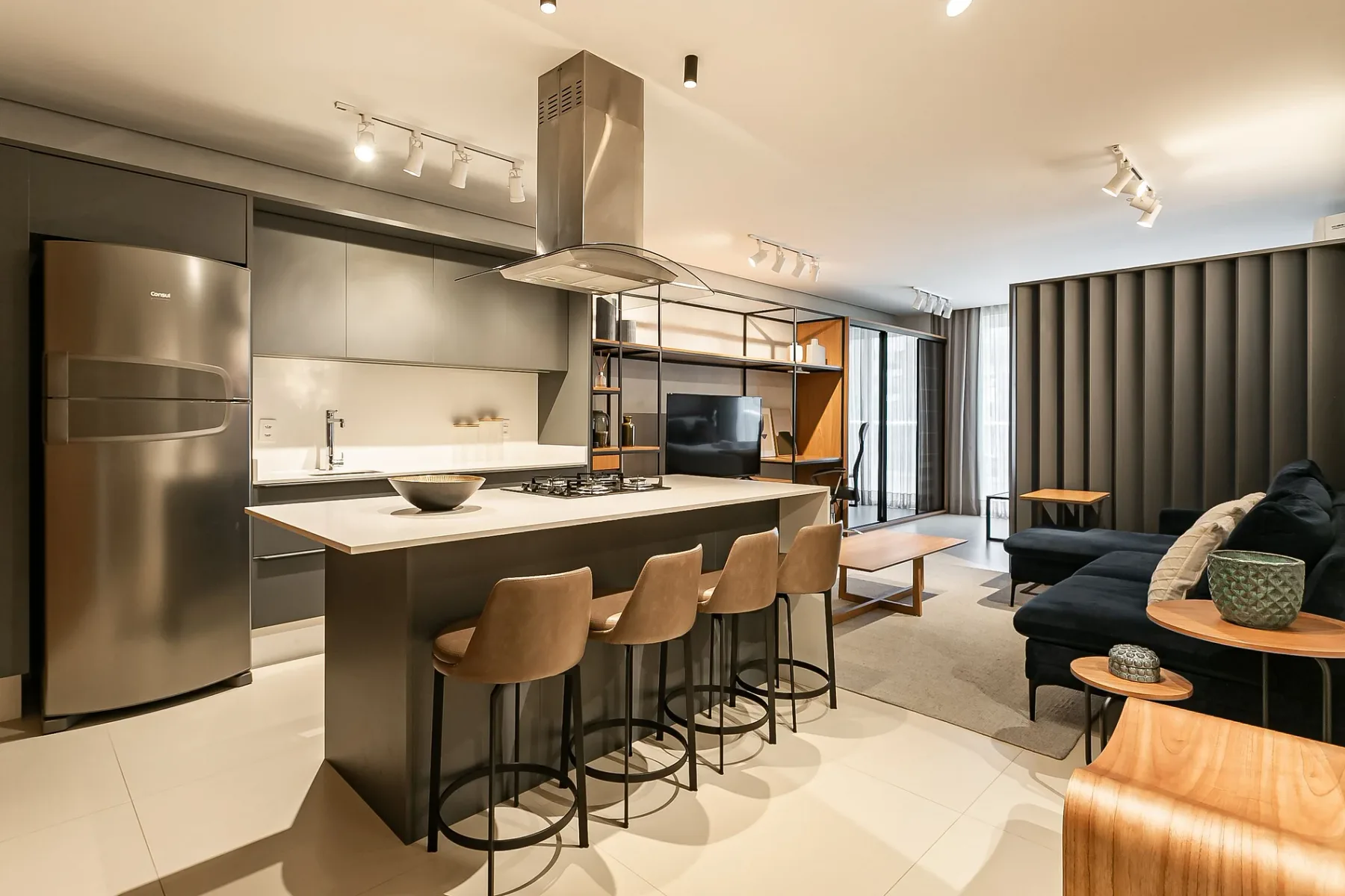 An open-plan kitchen and living area with a central island and seating.
