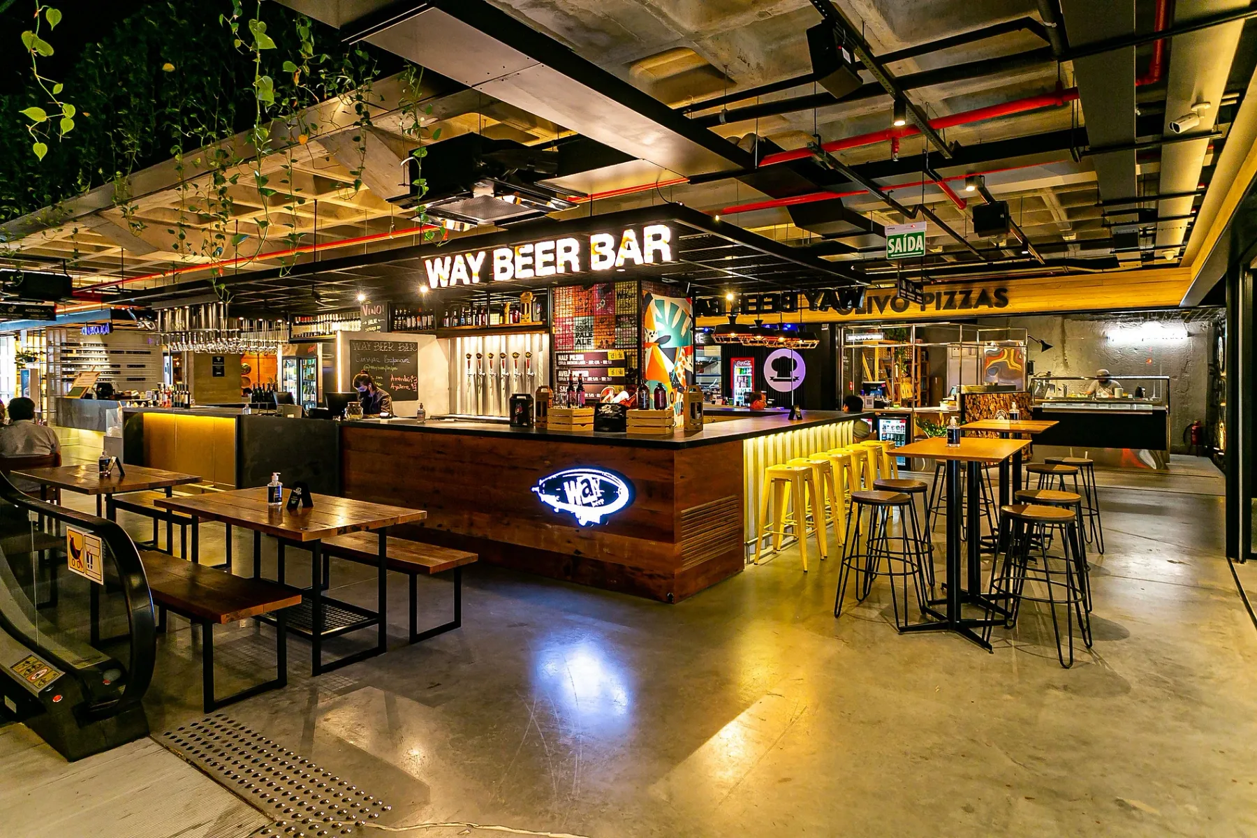 Shared amenity: A bar and dining area with a long counter and tables.