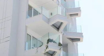 Representative hotel space: A modern building facade with glass balconies and angular overhangs.