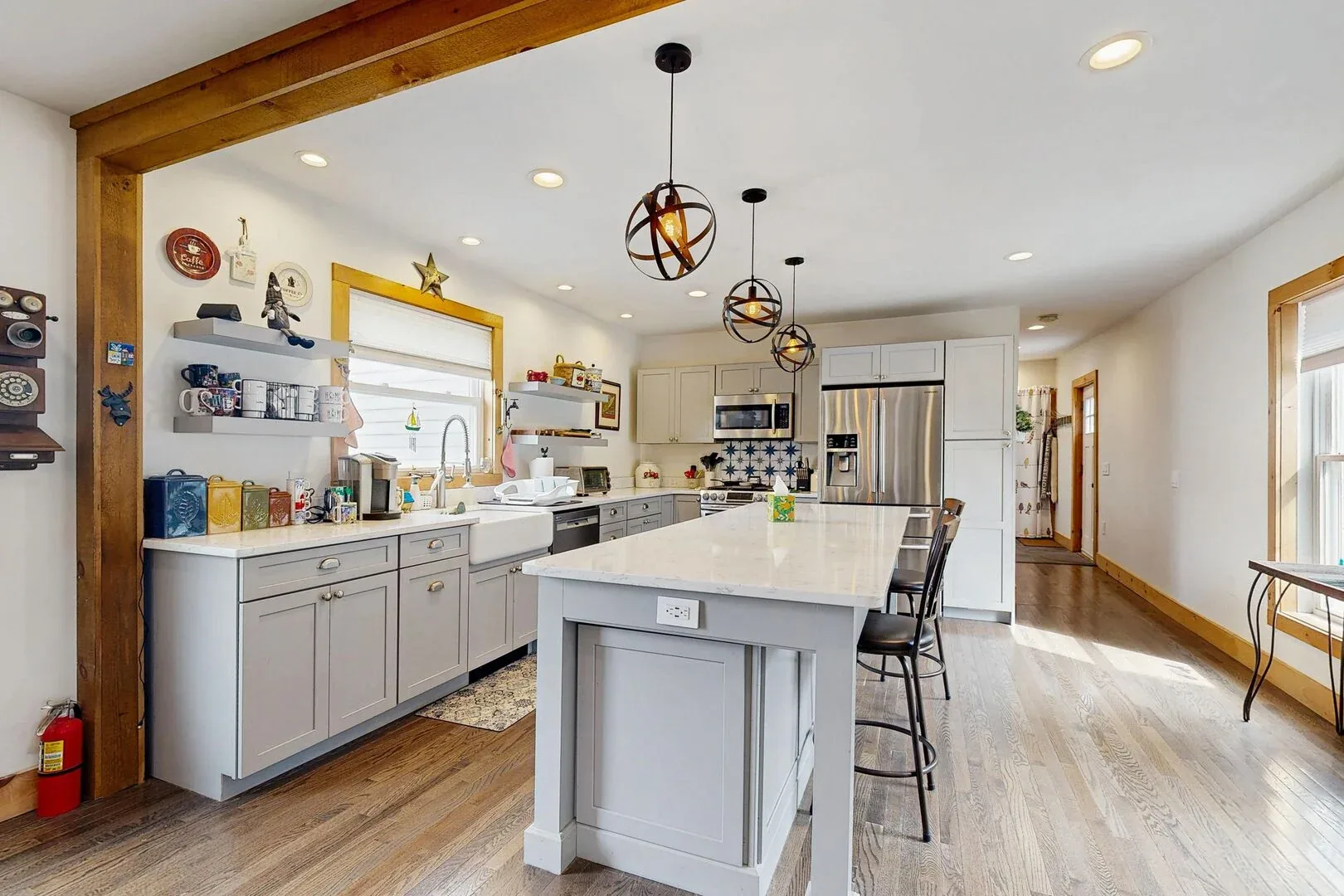 A bright kitchen with a large island and cabinetry along the walls.